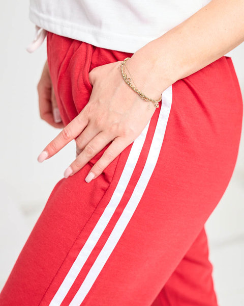 Жіночі червоні спортивні штани в смужку - Одяг