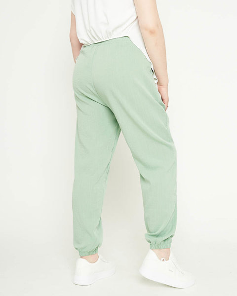 Жіночі штани з зеленої тканини - Одяг